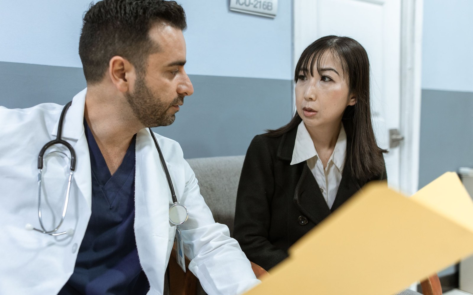 Doctor and patient reviewing medical documents during care coordination